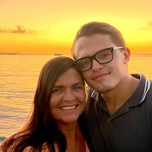 Profile picture of Deborah with a man and a sunset in the background on the sea