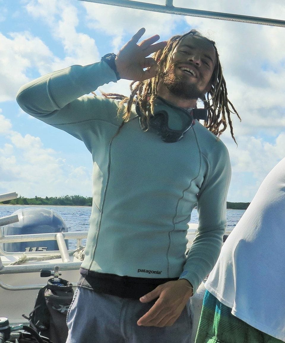 Jules waving Hello, standing on a boat